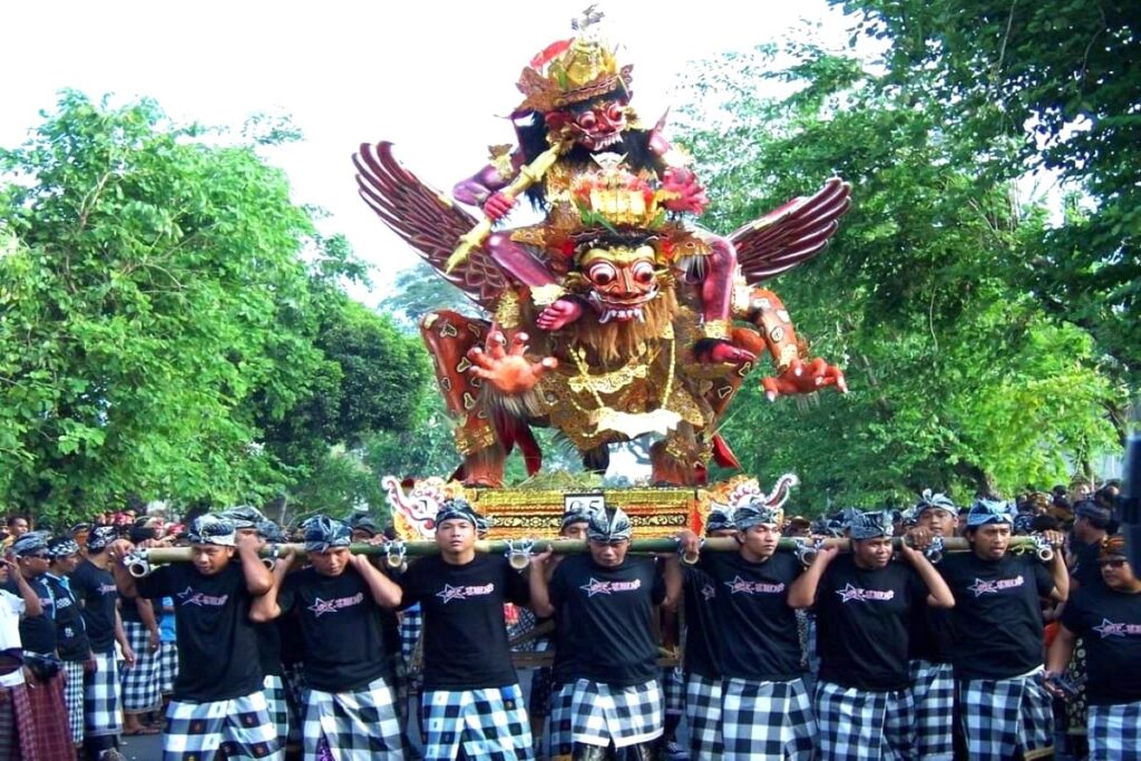 Balinese Ogoh-Ogoh parade carried by a crowd during traditional Nyepi festival procession in Bali